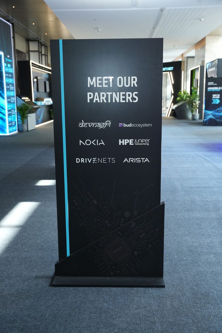 A "Meet our partners" board at the event listing Devnagri, Bud Ecosystem, Nokia, HPE Juniper Networking, DriveNets and Arista
