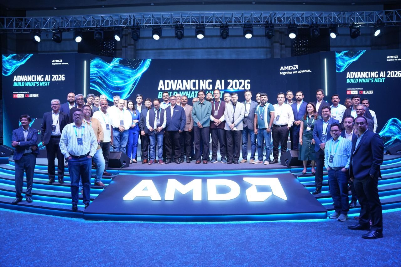Speakers, partners and guests gathered on stage in front of the Advancing AI 2026 "Build what's next" backdrop, with an illuminated AMD logo in the foreground